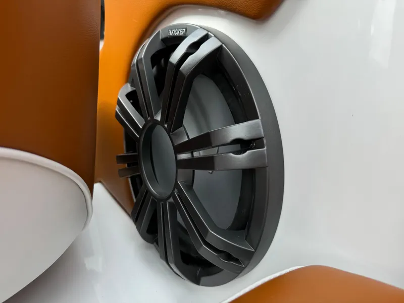 Slide: The Image of Close-up of a Kicker speaker in a 2025 Sanger 231SL boat interior. - 32
