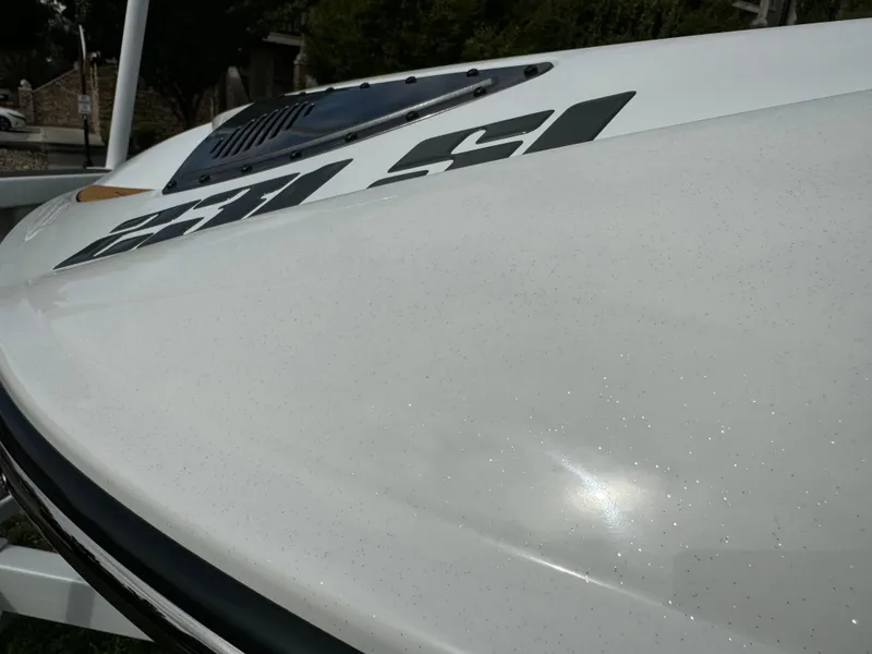 Slide: The Image of Close-up of a 2025 Sanger 231SL boat with sleek white finish. - 34