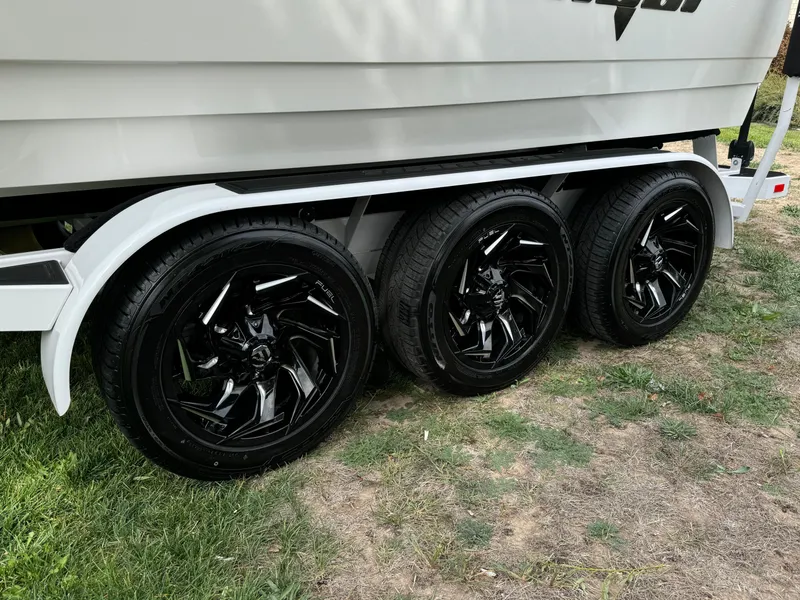 Slide: The Image of Sanger 231SL 2025 trailer with sleek black wheels on grass. - 35