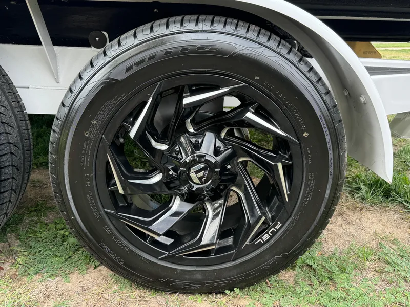 Slide: The Image of 2025 Sanger 231SL black alloy wheel on grass. - 36
