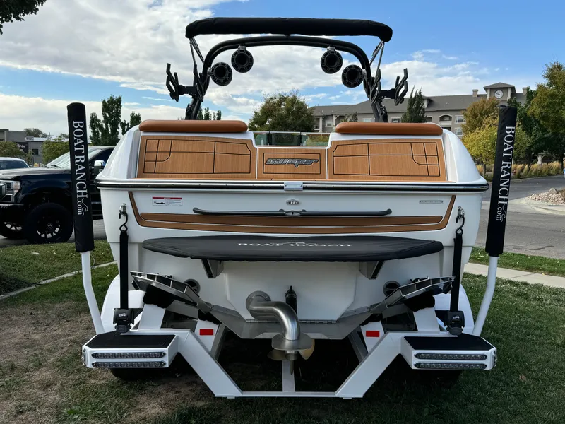 Slide: The Image of 2025 Sanger 231SL boat rear view with speakers and teak accents. - 4