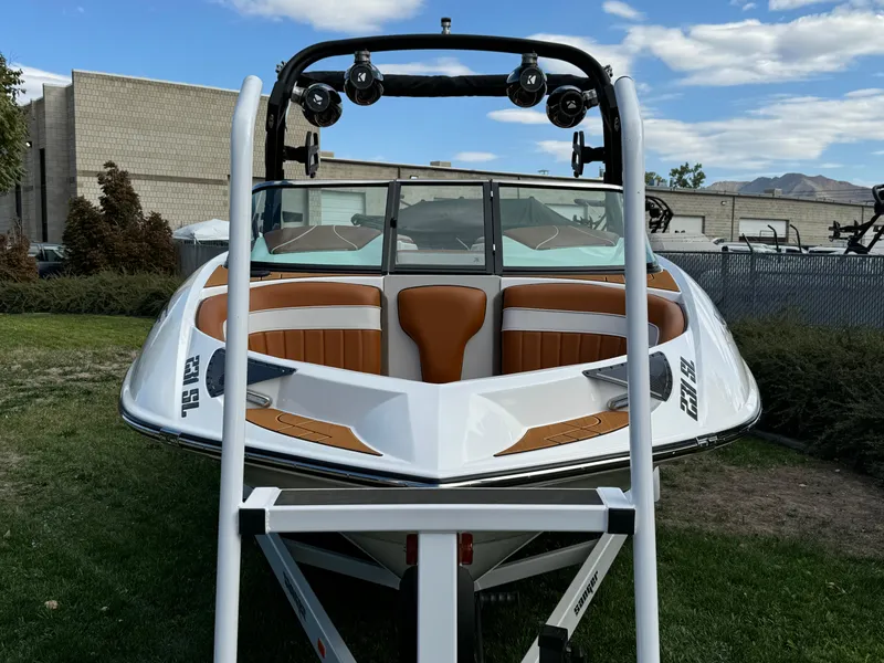 Slide: The Image of 2025 Sanger 231SL boat on trailer, featuring sleek design and orange interior accents. - 5