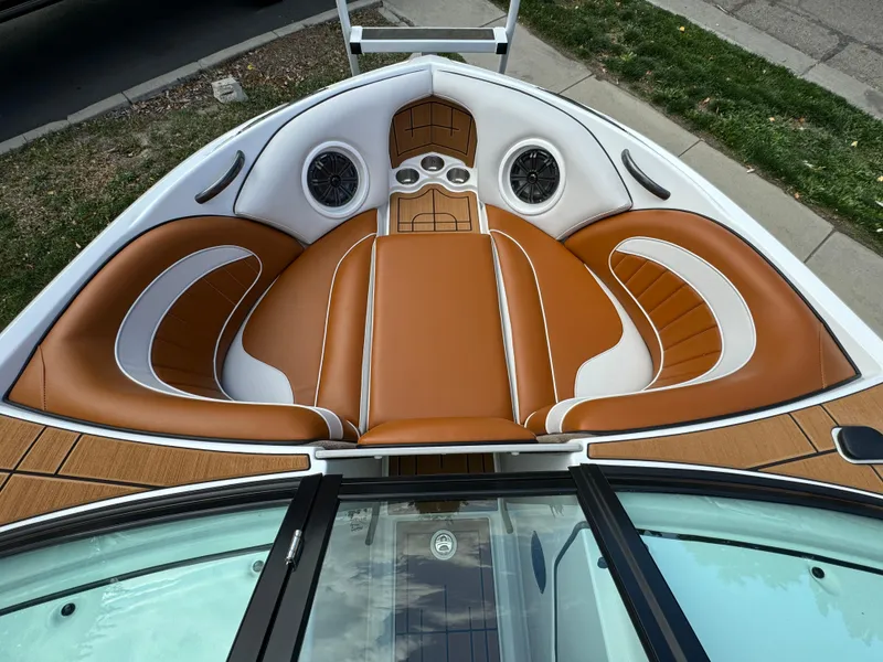 Slide: The Image of 2025 Sanger 231SL boat interior with brown and white cushioned seating. - 9