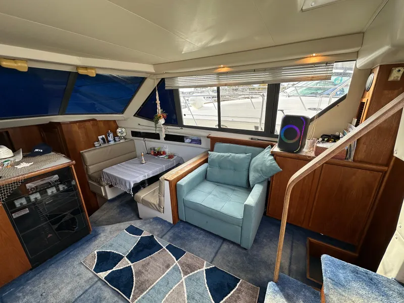 Slide: The Image of Interior of 1994 Carver 350 Aft Cabin Motor Yacht with cozy seating and modern decor. - 13