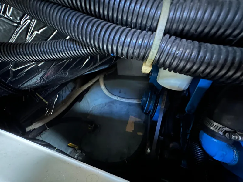 Slide: The Image of Engine compartment of a 1994 Carver 350 Aft Cabin Motor Yacht, showing hoses and components. - 25