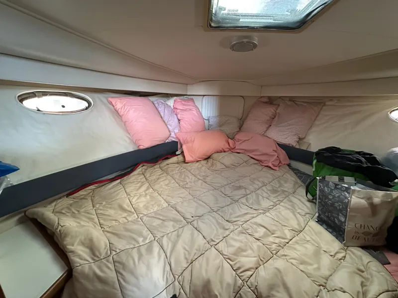 Slide: The Image of 1994 Carver 350 Aft Cabin Motor Yacht bedroom with cozy bedding and porthole windows. - 17