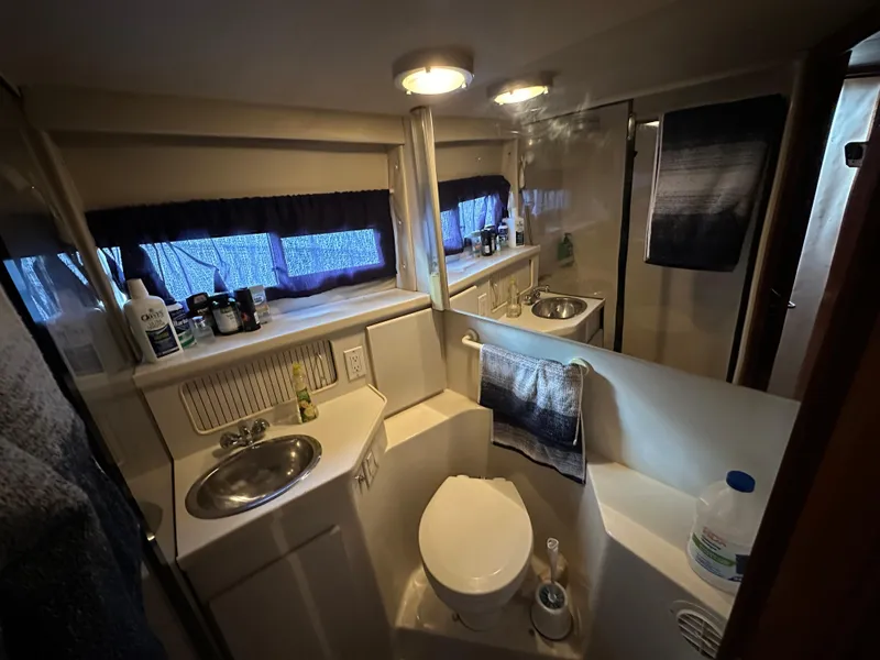 Slide: The Image of 1994 Carver 350 Aft Cabin Motor Yacht bathroom with sink, toilet, and mirror. - 21
