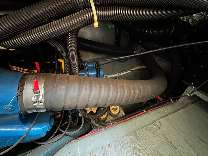 Slide: The Image of Engine room of 1994 Carver 350 Aft Cabin Motor Yacht with visible hoses and components. - 24