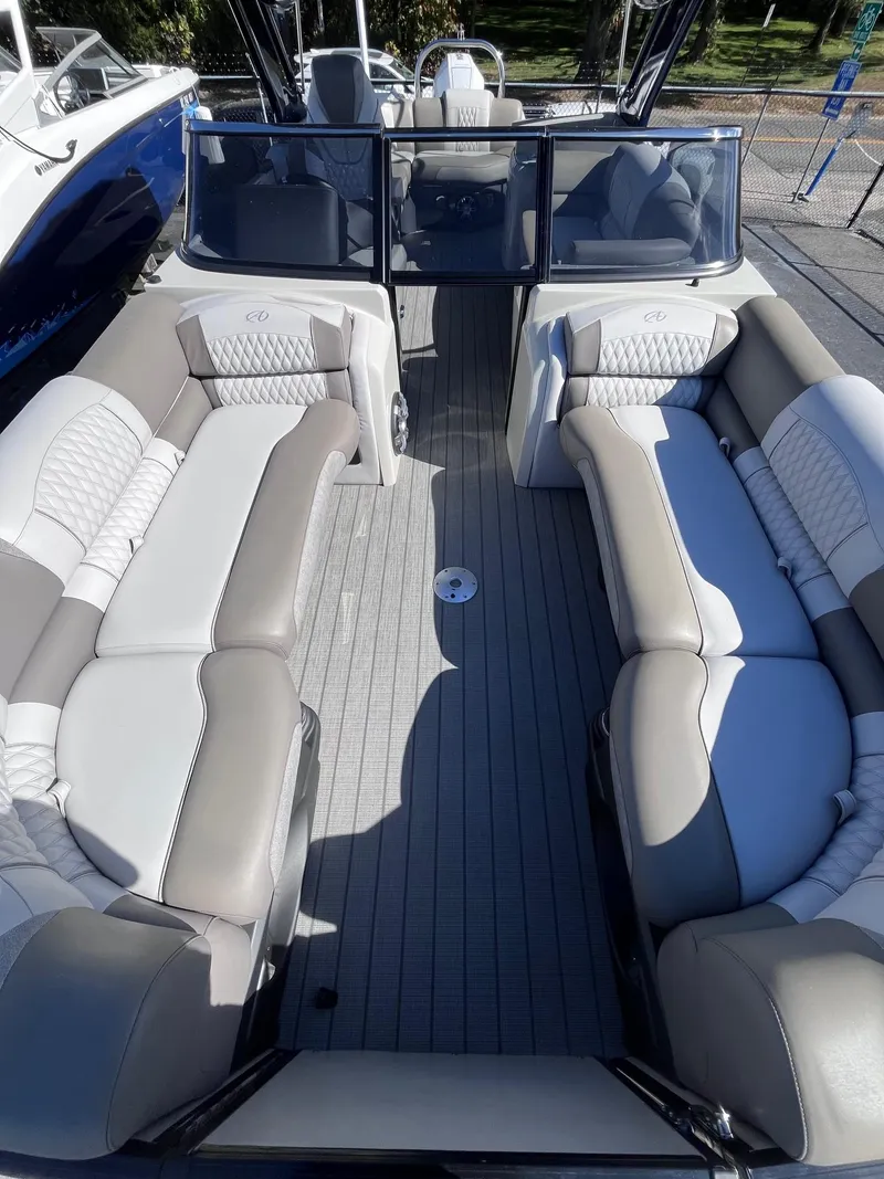Slide: The Image of 2023 Avalon Excalibur Elite Windshield 27' boat interior with luxurious seating. - 6