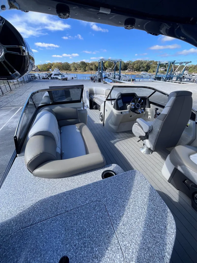 Slide: The Image of 2023 Avalon Excalibur Elite Windshield 27' boat interior with seating and steering console. - 8