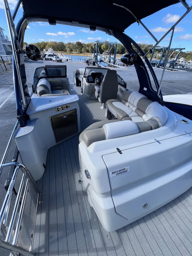 Slide: The Image of 2023 Avalon Excalibur Elite Windshield 27' boat interior with luxurious seating and modern amenities. - 9