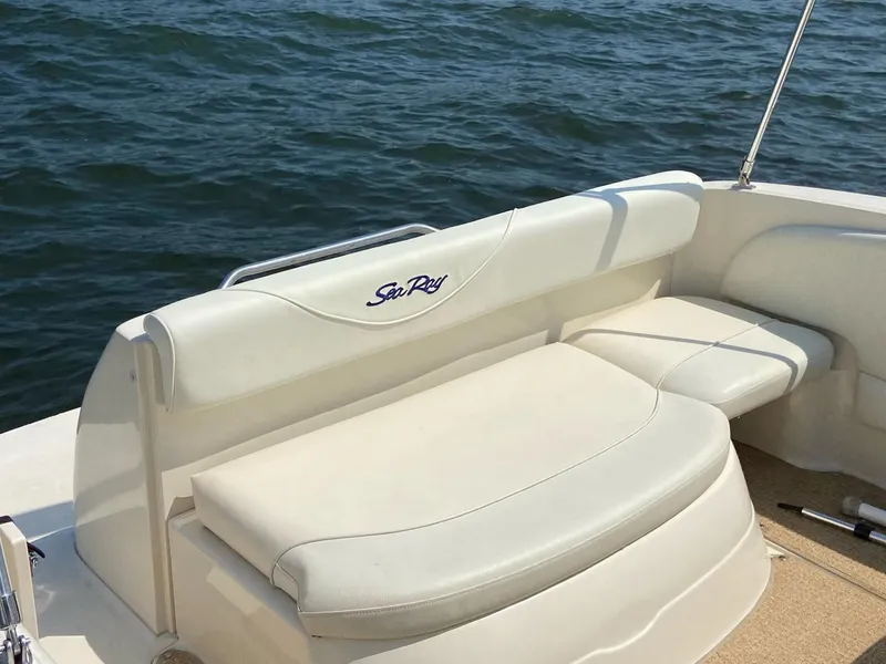 Slide: The Image of Sea Ray 245 Weekender 2000 boat interior with white seating, on calm water. - 3