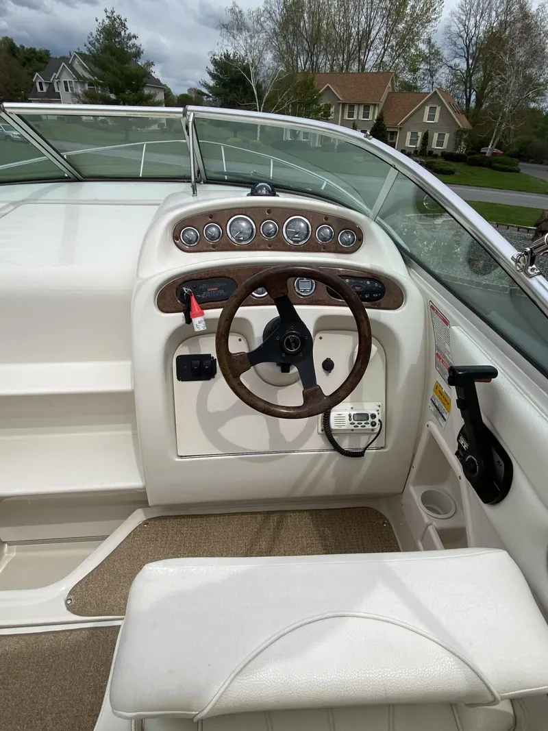 Slide: The Image of 2000 Sea Ray 245 Weekender boat cockpit with steering wheel and instrument panel. - 4