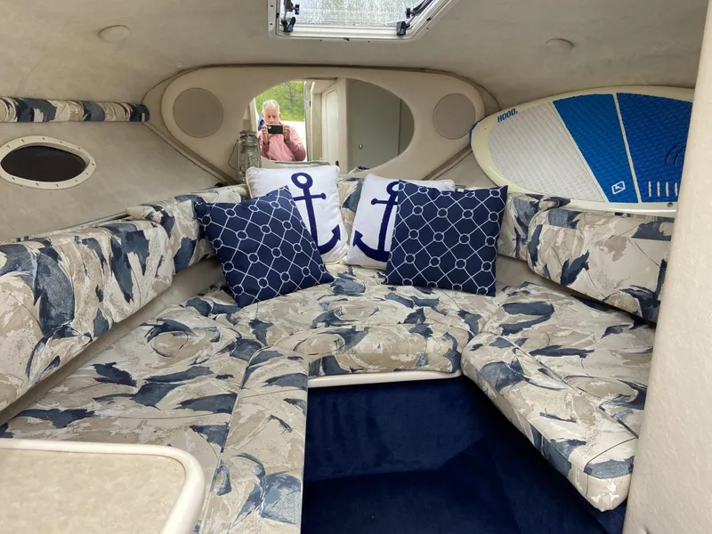Slide: The Image of Interior of 2000 Sea Ray 245 Weekender with nautical-themed cushions and surfboard. - 5