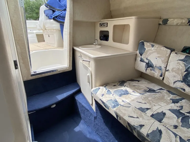 Slide: The Image of Interior of 2000 Sea Ray 245 Weekender with seating and compact kitchenette. - 6