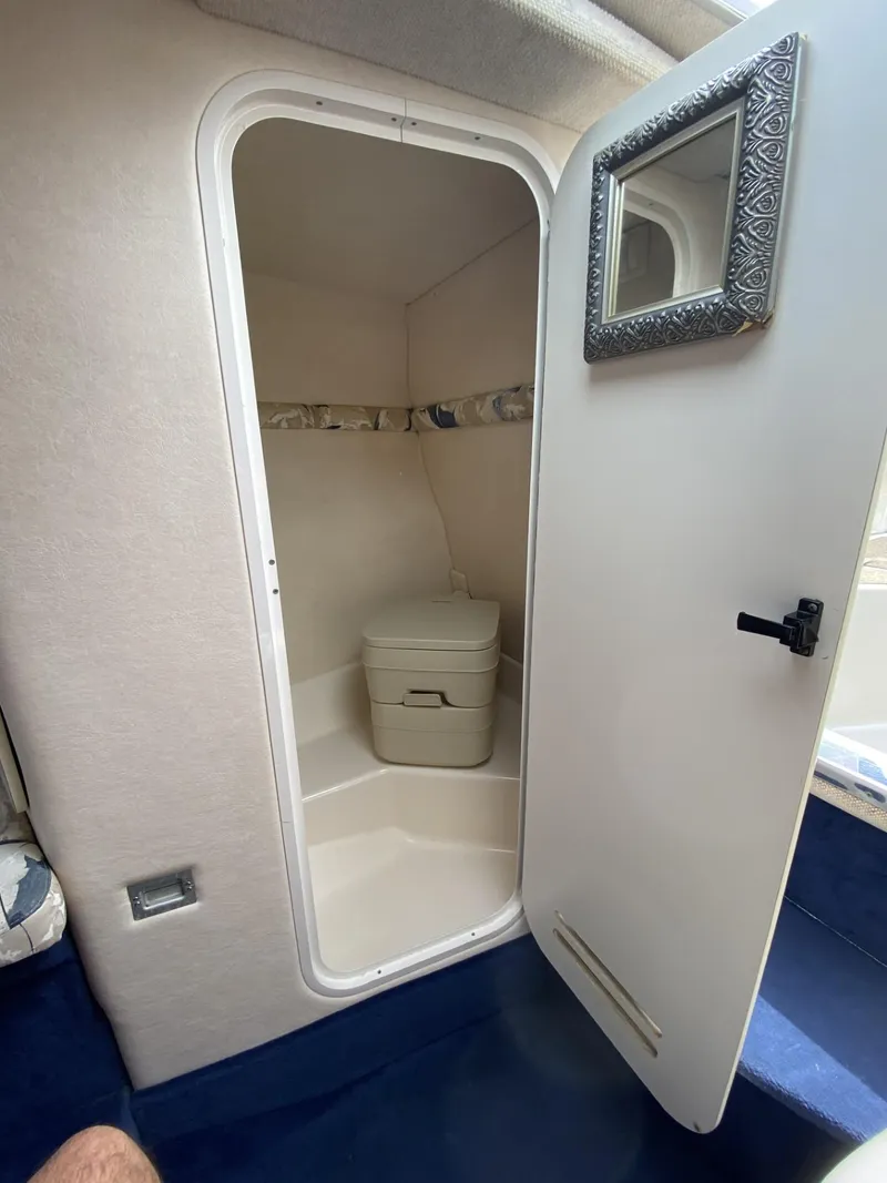 Slide: The Image of 2000 Sea Ray 245 Weekender cabin with compact bathroom and mirror. - 8