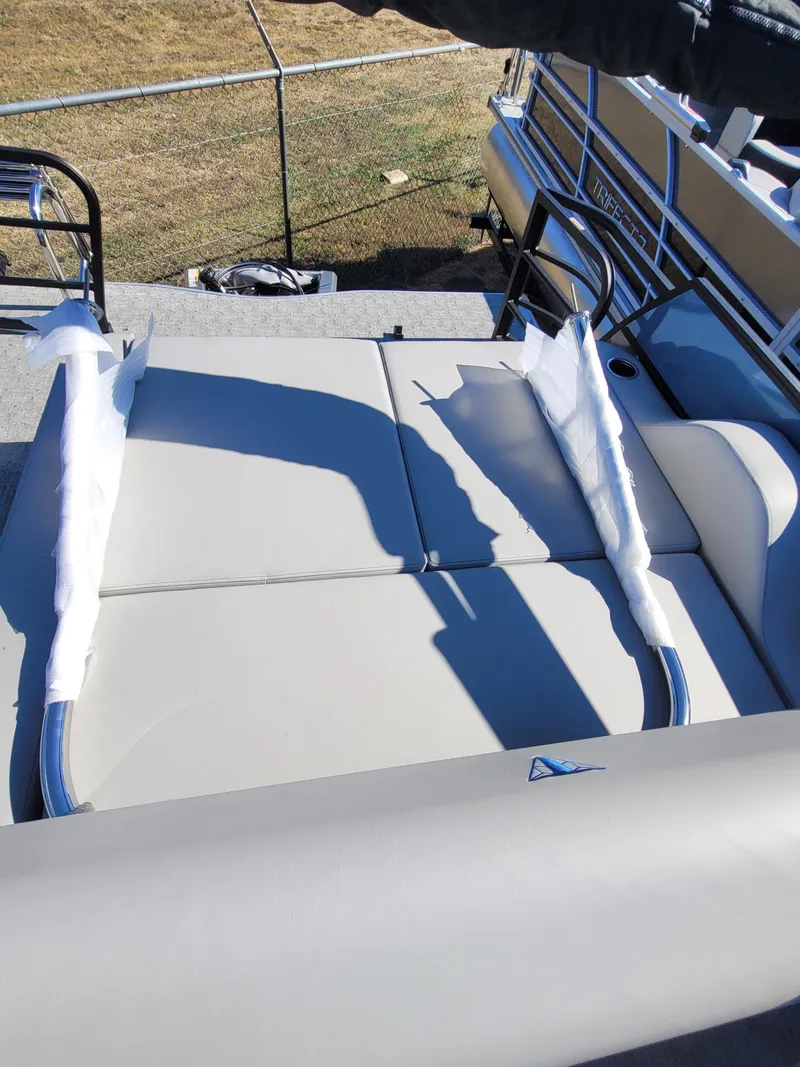 Slide: The Image of 2025 Trifecta 24ULLET275 boat seating with protective covers, outdoor setting. - 10