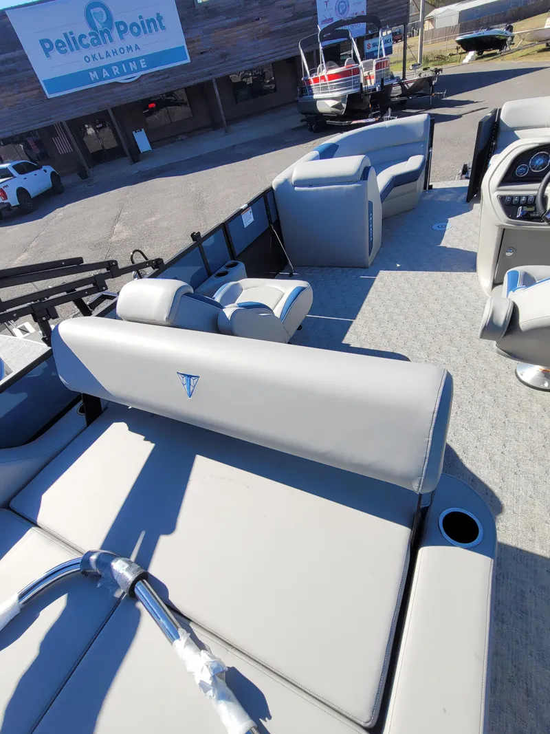 Slide: The Image of 2025 Trifecta 24ULLET275 pontoon boat with gray seating at Pelican Point Marina. - 11