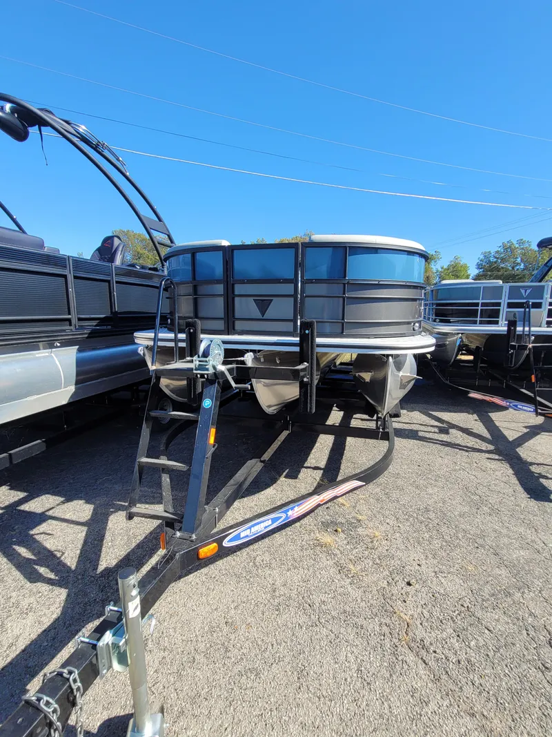 Slide: The Image of 2025 Trifecta 24ULLET275 pontoon boat on trailer under clear blue sky. - 3