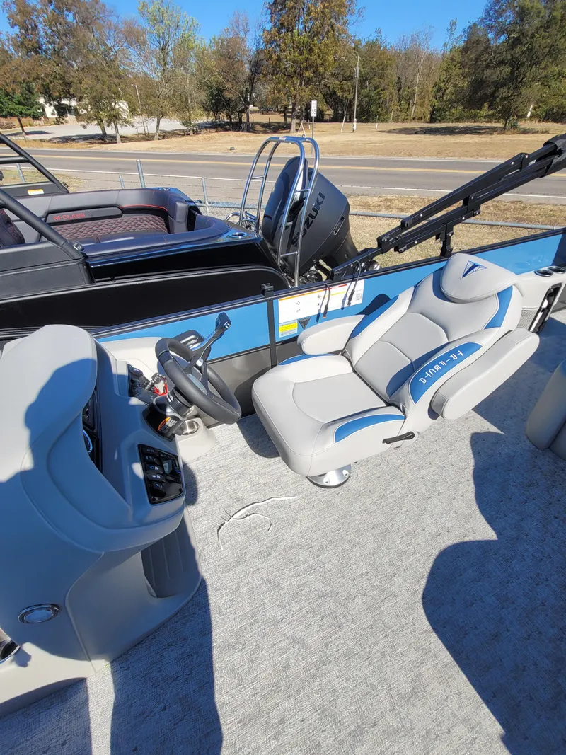 Slide: The Image of 2025 Trifecta 24ULLET275 boat interior with steering wheel and comfortable seating. - 8