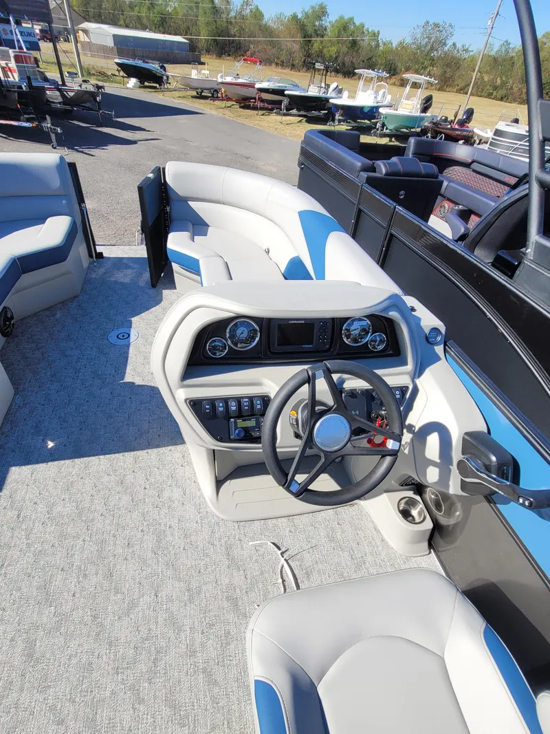 Slide: The Image of 2025 Trifecta 24ULLET275 boat interior with modern steering console and seating. - 9
