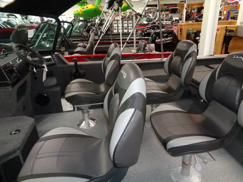 Slide: The Image of 2025 Lund 1875 Impact XS Sport boat interior with four cushioned seats. - 12