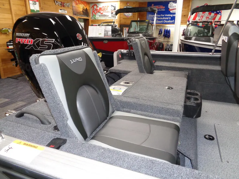 Slide: The Image of 2025 Lund 1875 Impact XS Sport boat interior with seating and Mercury Pro XS engine. - 14