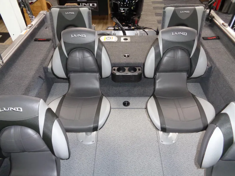Slide: The Image of 2025 Lund 1875 Impact XS Sport boat interior with gray seating and cup holders. - 17