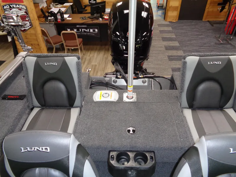 Slide: The Image of 2025 Lund 1875 Impact XS Sport boat interior with seating and motor. - 19