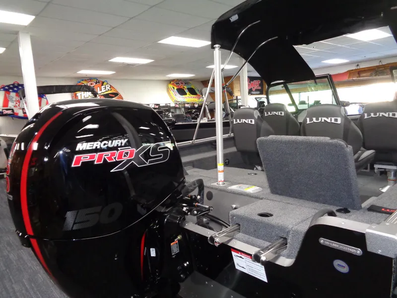 Slide: The Image of 2025 Lund 1875 Impact XS Sport boat with Mercury Pro XS 150 engine in showroom. - 26
