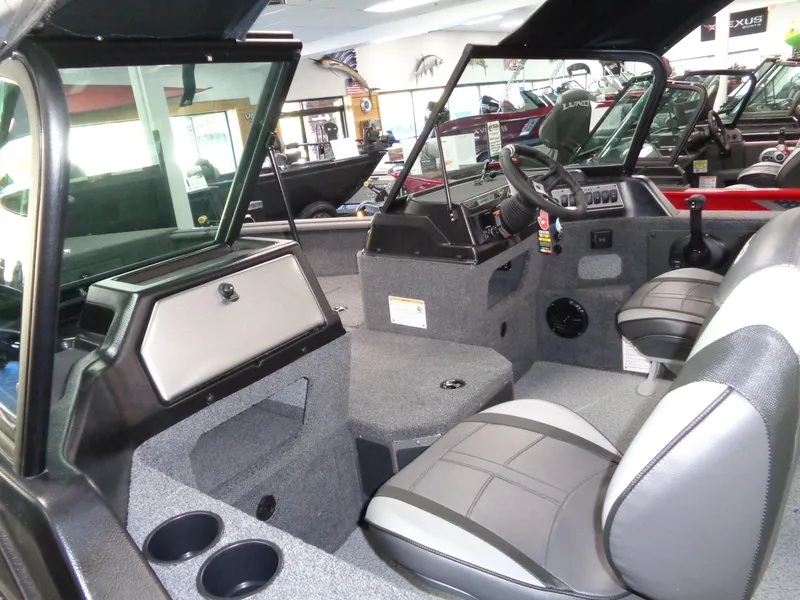 Slide: The Image of 2025 Lund 1875 Impact XS Sport boat interior with seating and dashboard. - 30