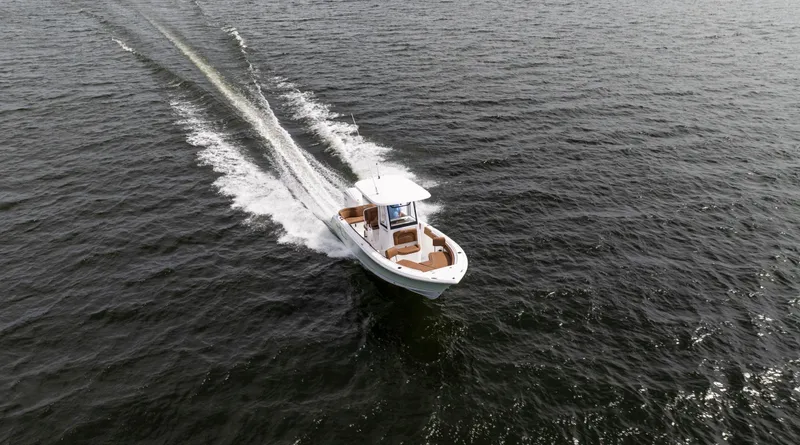 Slide: The Image of 2025 Sea Hunt Ultra 235 SE boat cruising on open water. - 16
