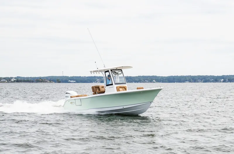 Slide: The Image of 2025 Sea Hunt Ultra 235 SE boat cruising on open water. - 2