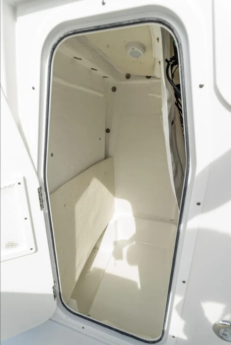 Slide: The Image of Interior cabin of 2025 Sea Hunt Ultra 235 SE boat, featuring sleek white design. - 6