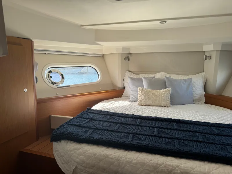 Slide: The Image of Luxurious bedroom interior of 2020 Beneteau Swift Trawler 41 Fly yacht. - 10