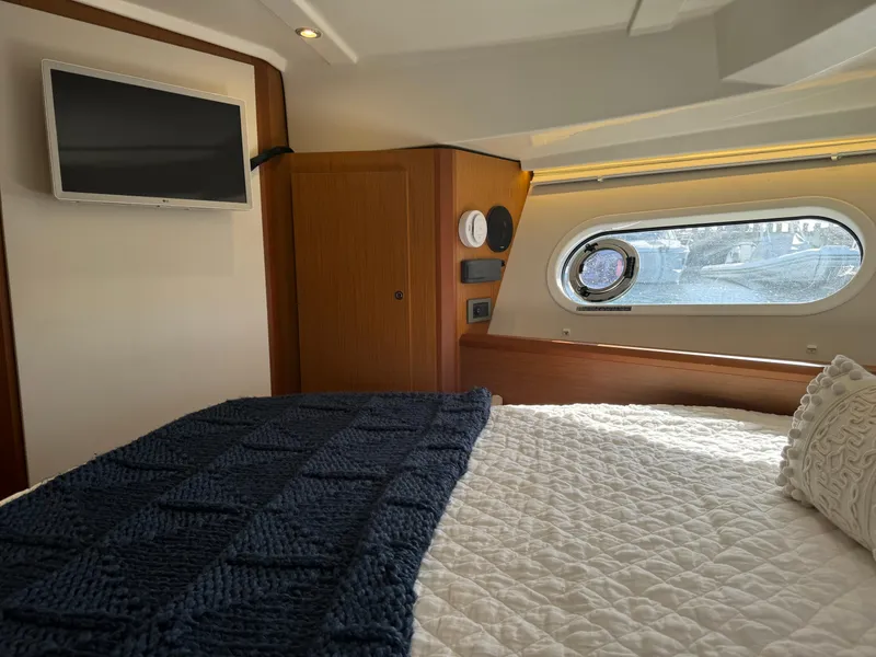 Slide: The Image of Luxurious cabin interior of 2020 Beneteau Swift Trawler 41 Fly with cozy bedding. - 12