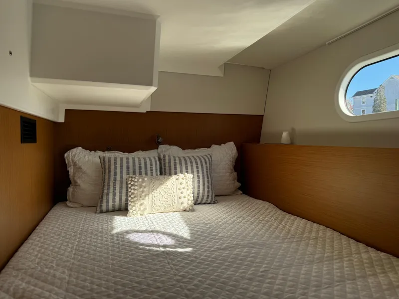 Slide: The Image of Cozy cabin interior of 2020 Beneteau Swift Trawler 41 Fly with plush bedding. - 16