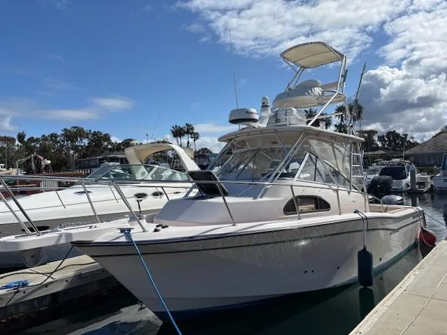 Slide: The Image of 2009 Grady-White Marlin 300 boat docked at marina under blue sky. - 1