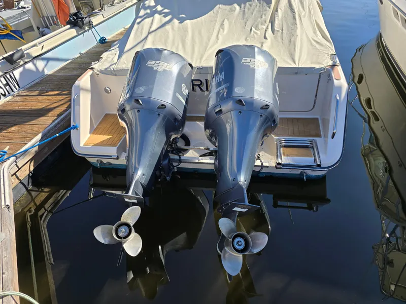Slide: The Image of 2009 Grady-White Marlin 300 with twin outboard engines docked at marina. - 11