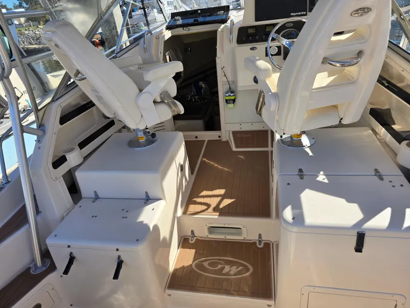 Slide: The Image of 2009 Grady-White Marlin 300 boat interior with helm and seating area. - 12