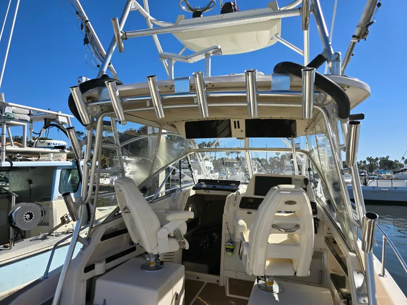 Slide: The Image of 2009 Grady-White Marlin 300 boat interior with helm and seating, docked at marina. - 13