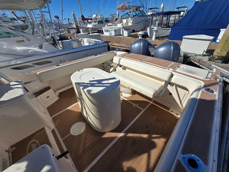 Slide: The Image of 2009 Grady-White Marlin 300 boat interior with seating and deck view at marina. - 16