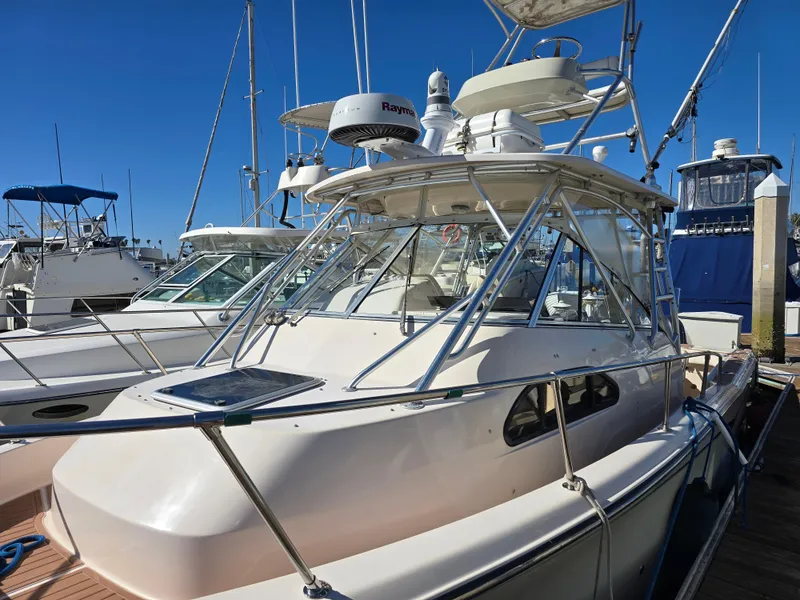 Slide: The Image of 2009 Grady-White Marlin 300 boat docked, featuring radar equipment and sleek design. - 17