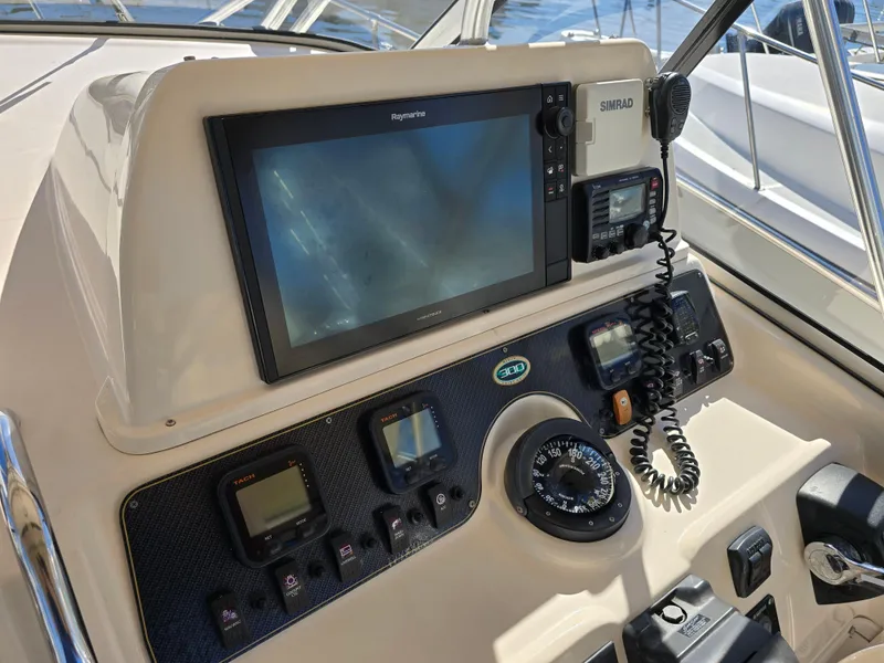 Slide: The Image of 2009 Grady-White Marlin 300 boat dashboard with navigation equipment and controls. - 21