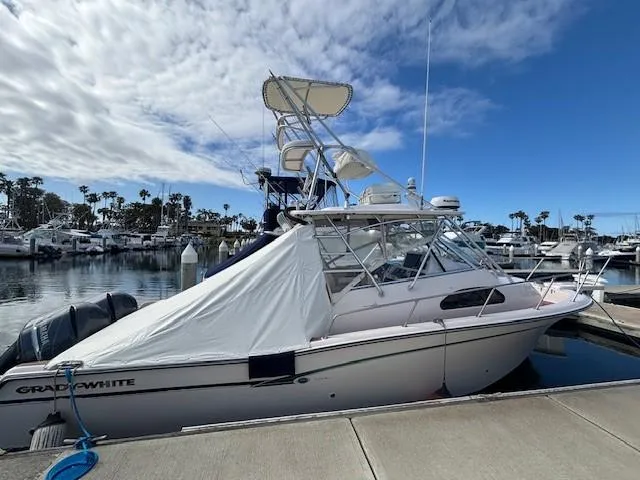 Slide: The Image of 2009 Grady-White Marlin 300 boat docked at marina under cloudy sky. - 3