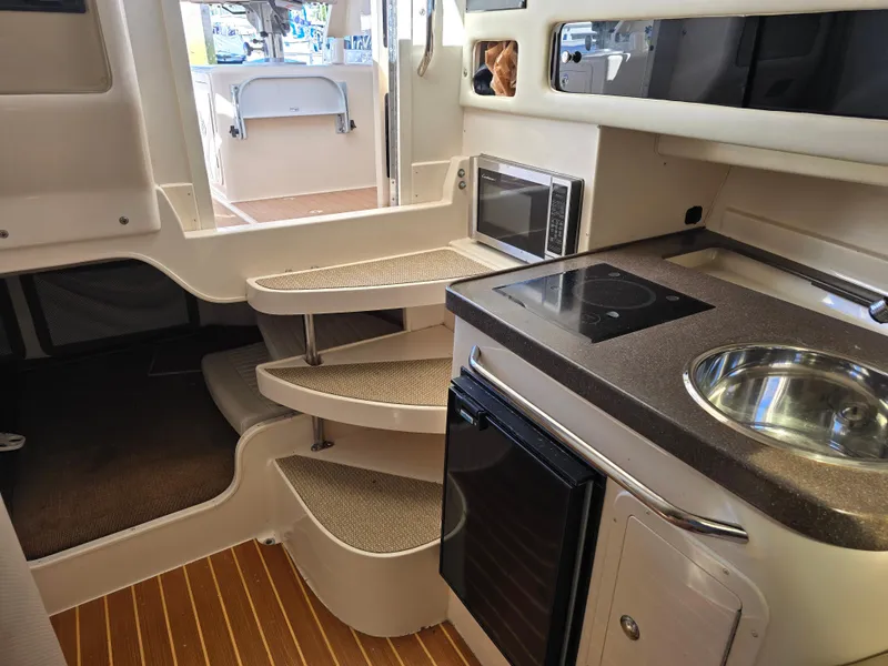 Slide: The Image of Interior of 2009 Grady-White Marlin 300 boat with kitchenette and stairs. - 36