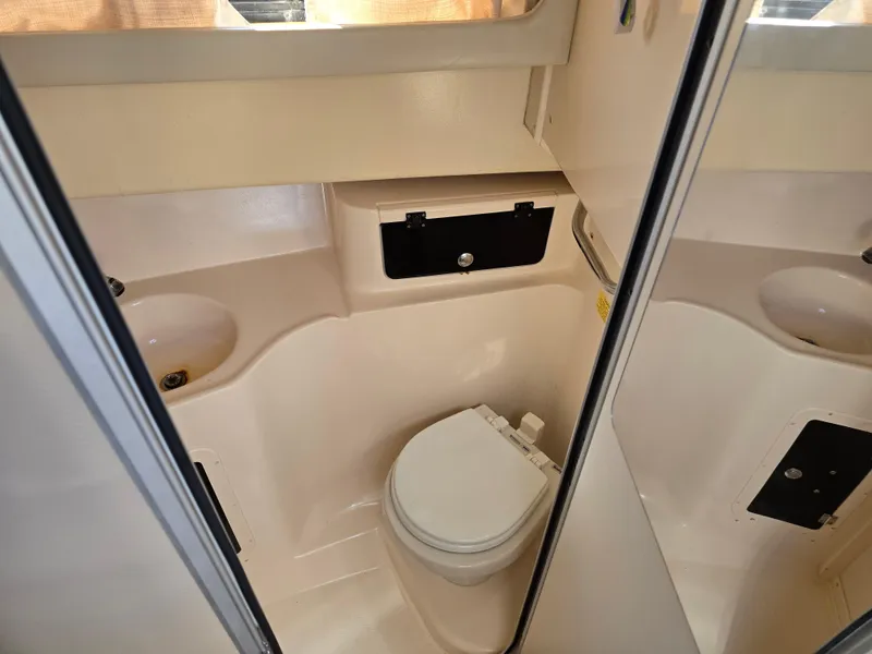 Slide: The Image of 2009 Grady-White Marlin 300 boat bathroom interior with toilet and sink. - 37