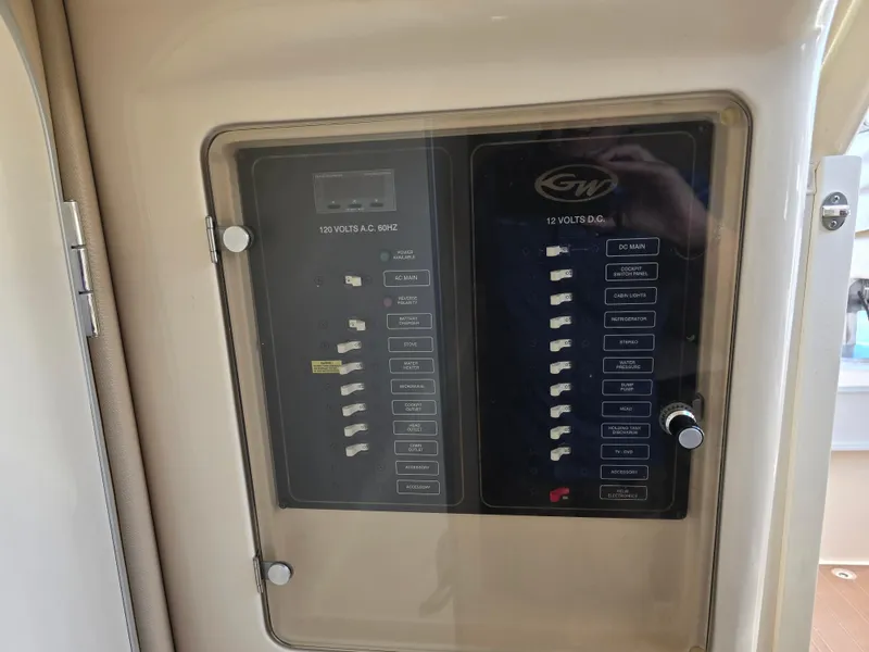 Slide: The Image of Control panel of a 2009 Grady-White Marlin 300 boat, featuring switches and indicators. - 38