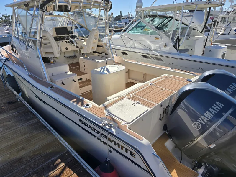 Slide: The Image of 2009 Grady-White Marlin 300 boat with Yamaha engines docked at marina. - 5
