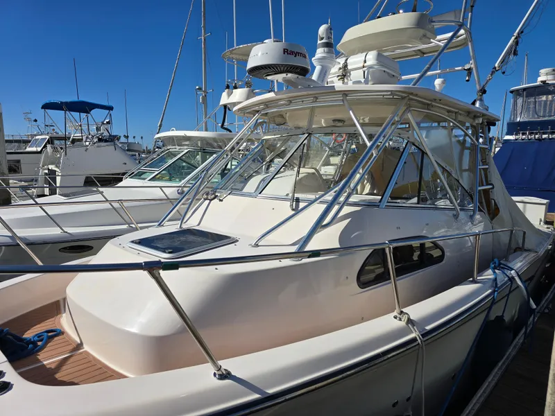Slide: The Image of 2009 Grady-White Marlin 300 boat docked at marina under clear blue sky. - 8